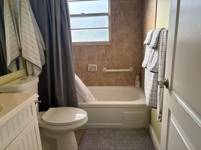 a bathroom with a sink a toilet and bathtub