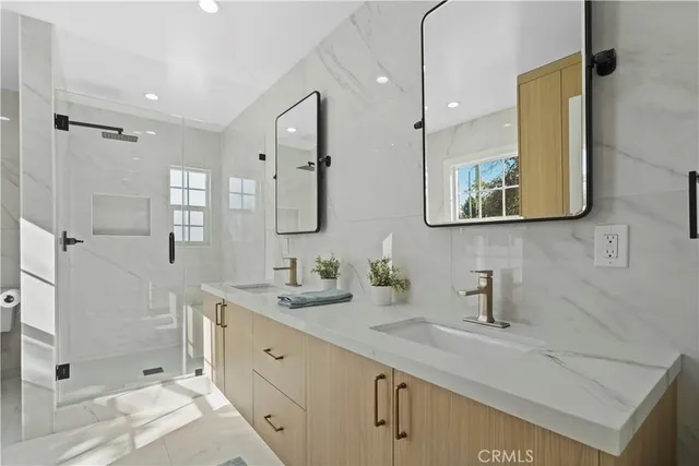 a bathroom with a double vanity sink mirror and