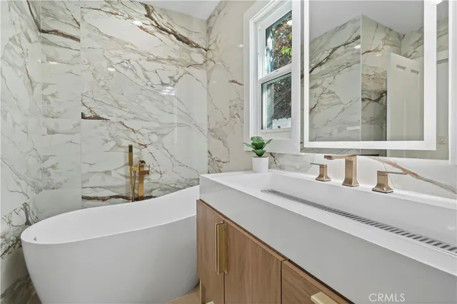 a bathroom with a bathtub and a sink