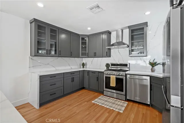 a kitchen with stainless steel appliances granite countertop a stove and a sink