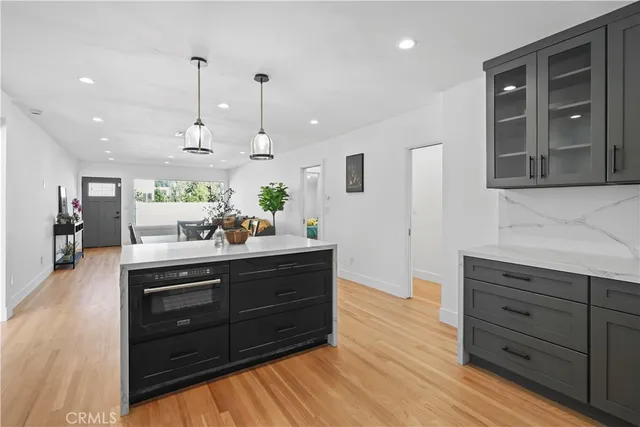 a spacious bathroom with a granite countertop sink and a mirror
