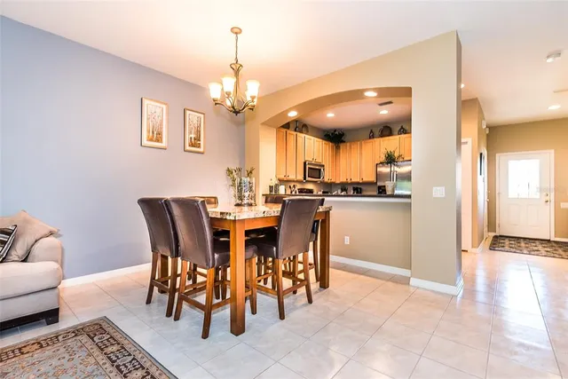 a view of a dining room with furniture and chandelier