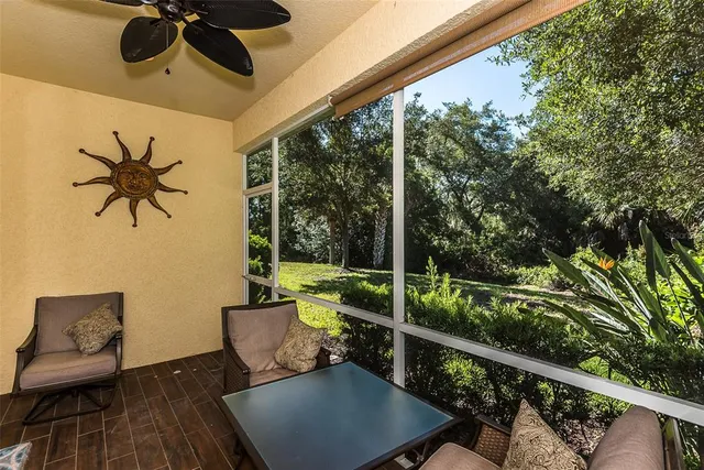 a view of a porch with furniture and a yard