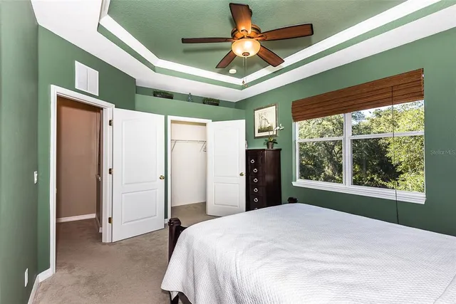 a bedroom with a large bed and a large window