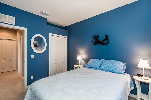 a bedroom with a bed and a mirror