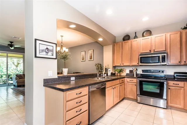 a kitchen with stainless steel appliances granite countertop a stove sink and cabinets