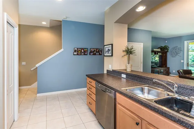 a kitchen with granite countertop a sink and a stove