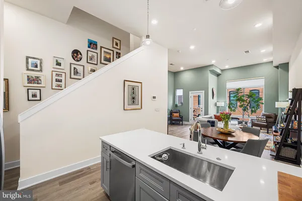 a kitchen with stainless steel appliances granite countertop a sink and a refrigerator