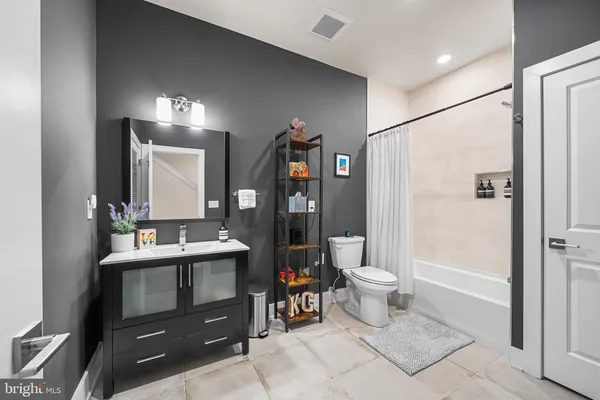 a bathroom with a toilet sink and shower