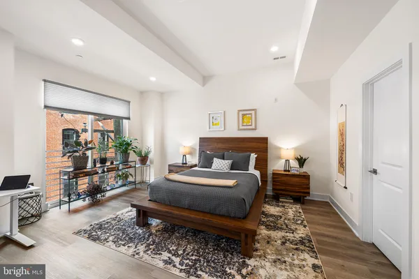 a bedroom with a bed and wooden floor