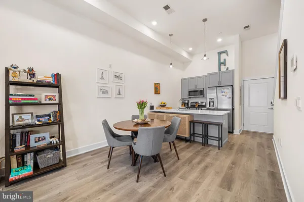 a view of a dining room with furniture and wooden floor