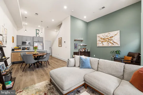 a living room with furniture and kitchen view