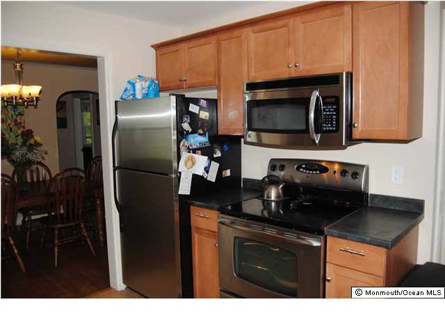 76 Freehold Road Manalapan, NJ 07726 - Photo 2 of 3 a kitchen with stainless steel appliances granite countertop a refrigerator stove and microwave