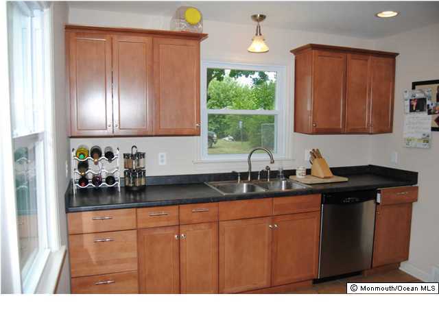 76 Freehold Road Manalapan, NJ 07726 - Photo 3 of 3 a kitchen with stainless steel appliances granite countertop a sink stove and cabinets