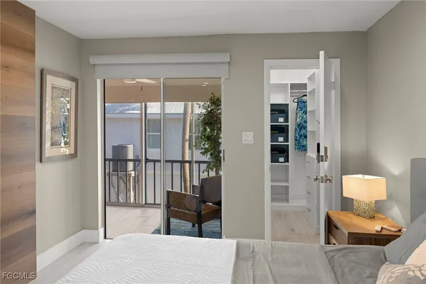 a bedroom with furniture and a potted plant