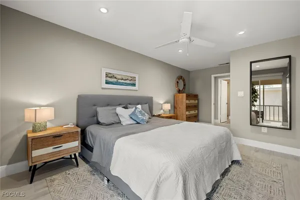 a bedroom with a large bed and a chandelier