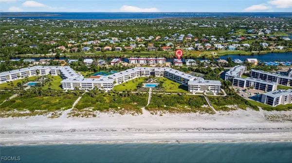 an aerial view of residential houses with outdoor space and lake view