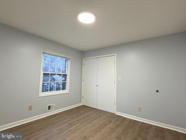 5915 Kingsford Road, Unit 365 Springfield, VA 22152 - Photo 19 of 28 a view of an empty room with a window and wooden floor