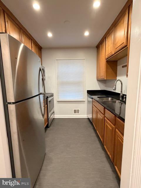 5915 Kingsford Road, Unit 365 Springfield, VA 22152 - Photo 7 of 28 a kitchen with stainless steel appliances a refrigerator and a sink