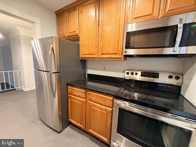 5915 Kingsford Road, Unit 365 Springfield, VA 22152 - Photo 8 of 28 a kitchen with stainless steel appliances granite countertop a refrigerator microwave and sink