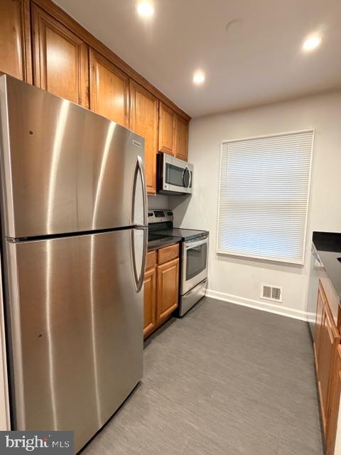 5915 Kingsford Road, Unit 365 Springfield, VA 22152 - Photo 10 of 28 a kitchen with stainless steel appliances granite countertop a refrigerator a microwave a sink and a refrigerator