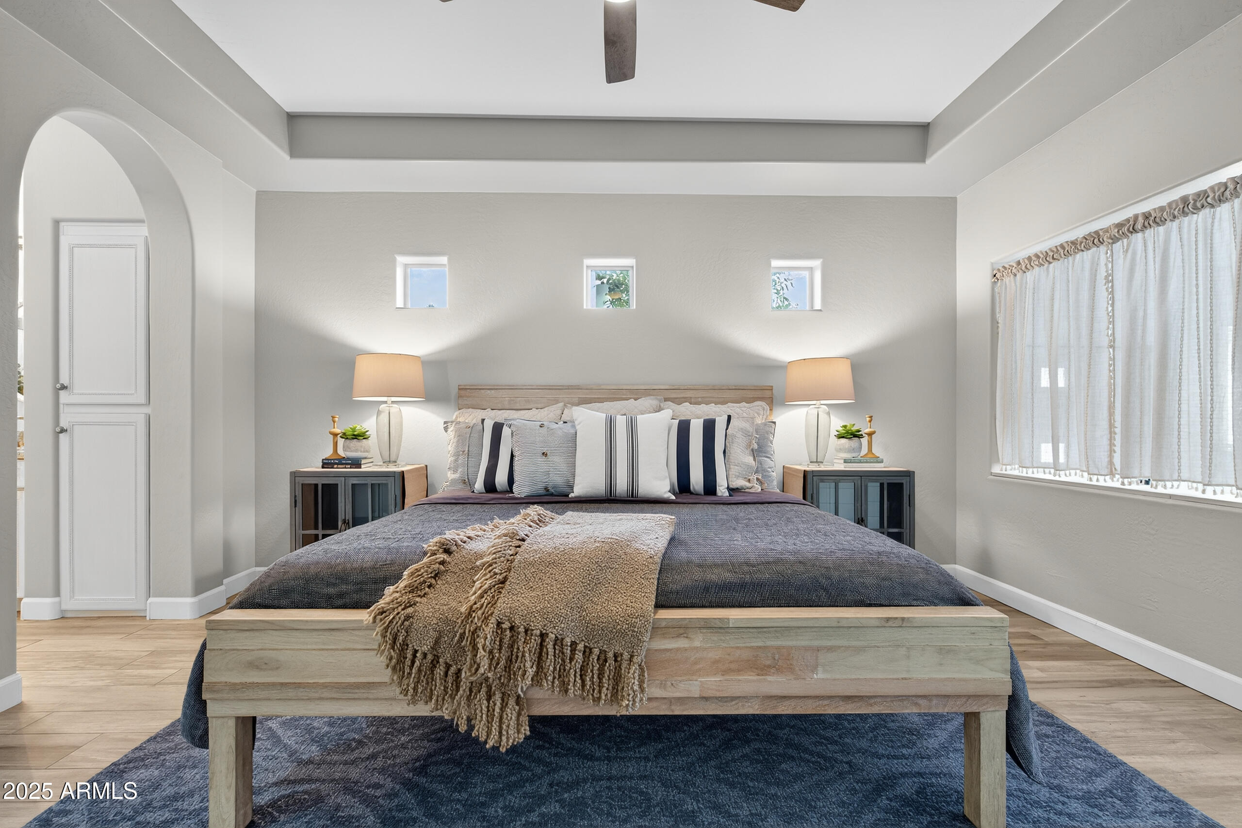 3021 East Agritopia Loop North Gilbert, AZ 85296 - Photo 18 of 68 a bedroom with a bed two lamps and a window