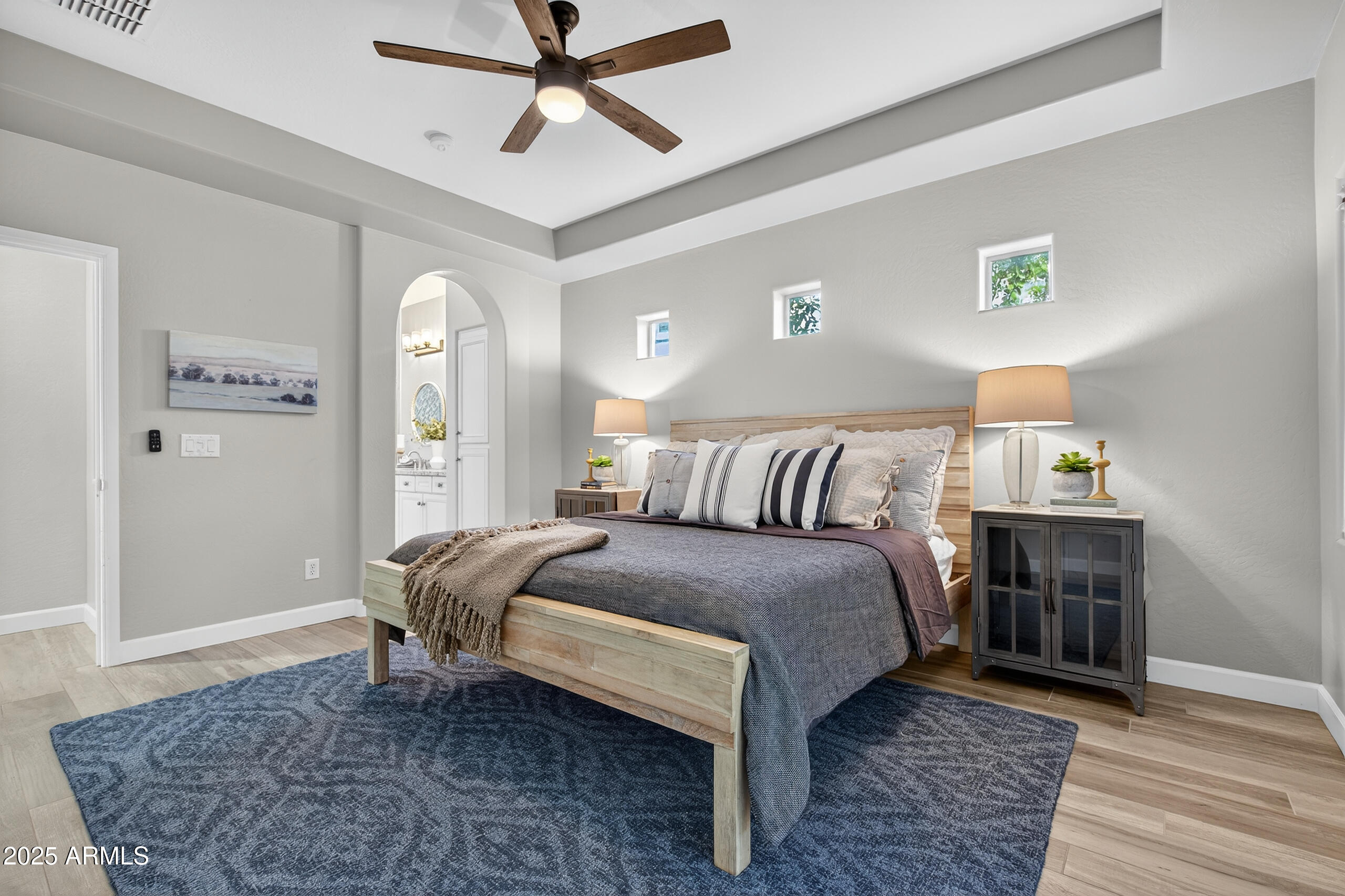 3021 East Agritopia Loop North Gilbert, AZ 85296 - Photo 19 of 68 a bedroom with a bed and wooden floor