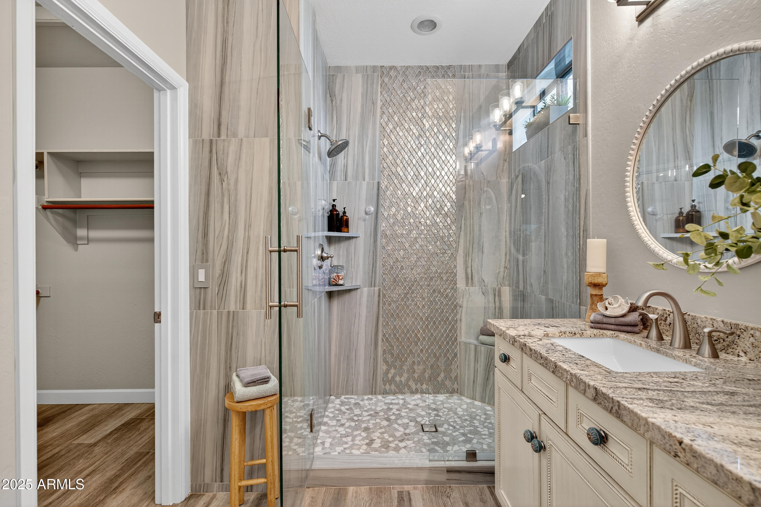 3021 East Agritopia Loop North Gilbert, AZ 85296 - Photo 20 of 68 a bathroom with a granite countertop sink a mirror and shower