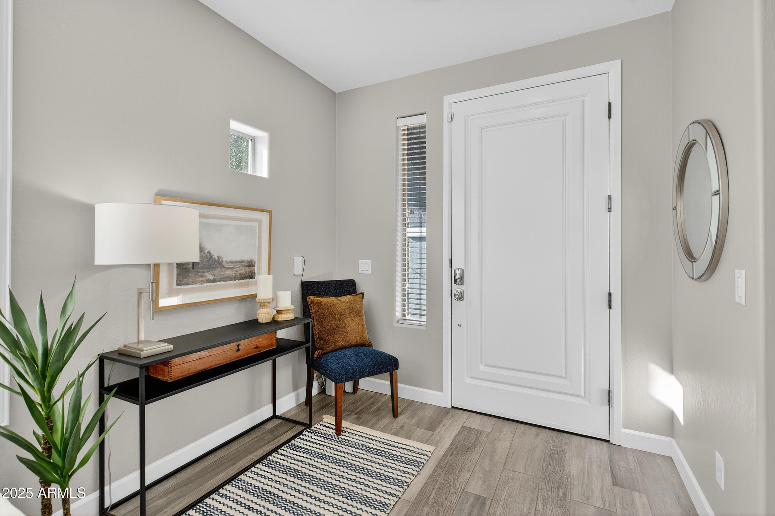 3021 East Agritopia Loop North Gilbert, AZ 85296 - Photo 2 of 68 a living room with furniture and a potted plant next to a window
