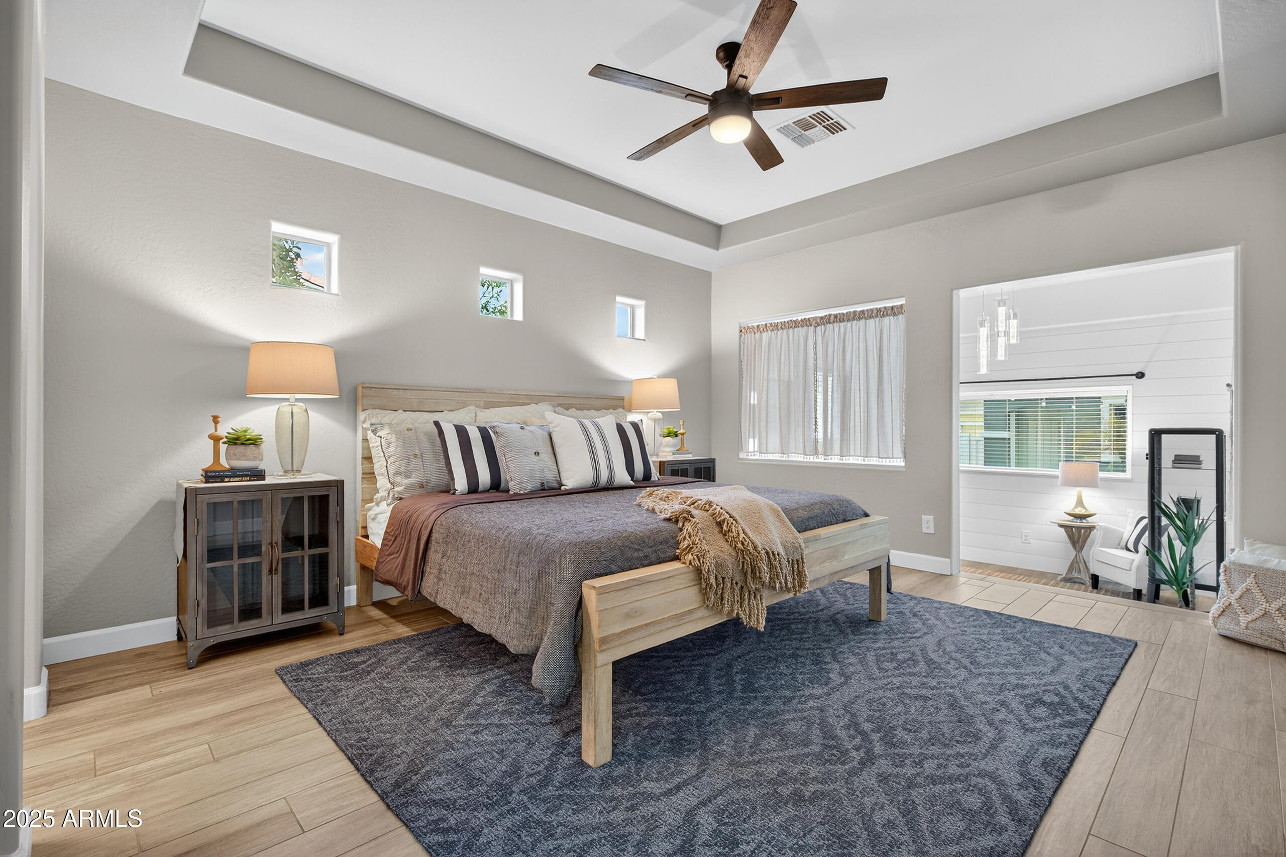 3021 East Agritopia Loop North Gilbert, AZ 85296 - Photo 22 of 68 a spacious bedroom with a bed a dresser and wooden floor