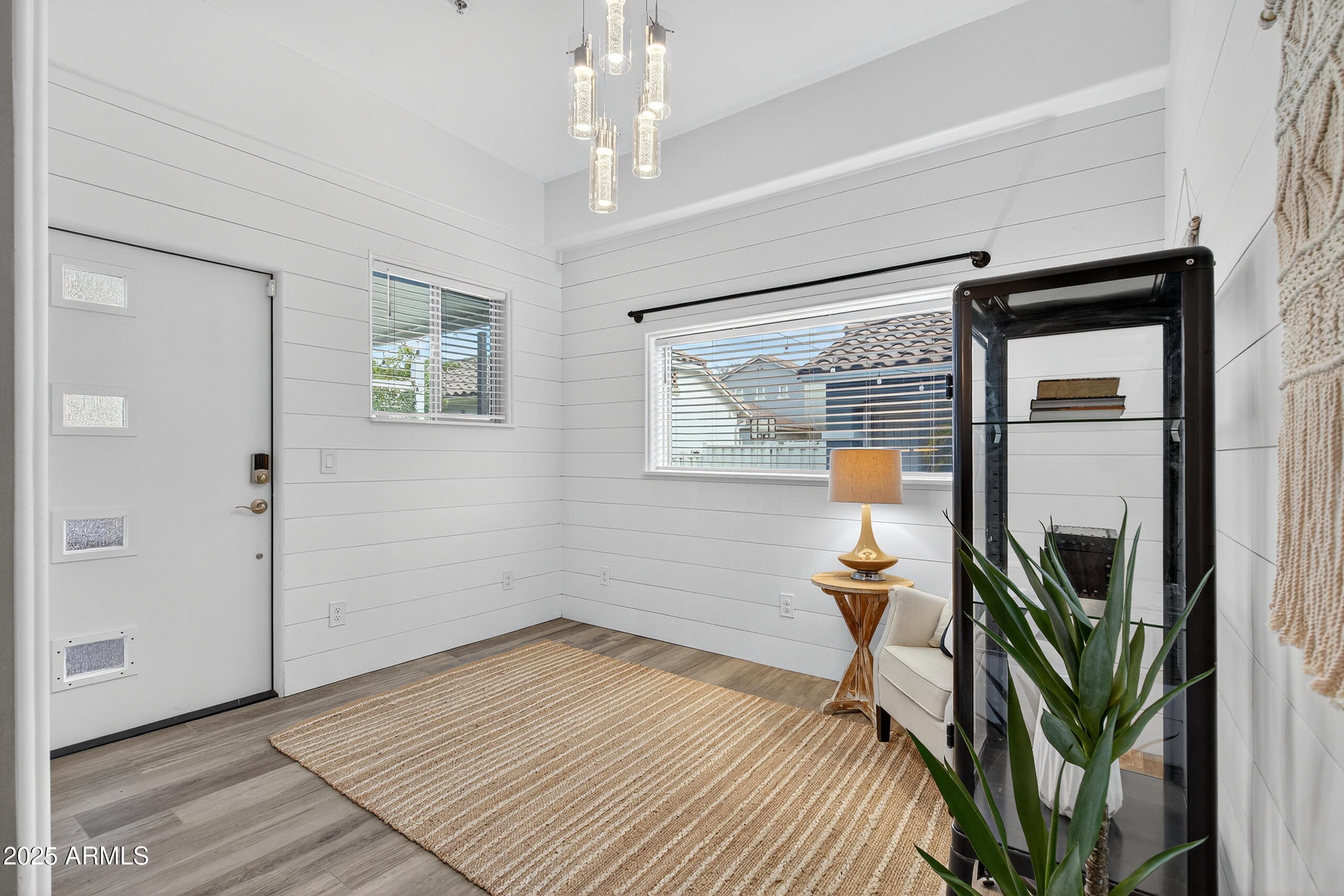 3021 East Agritopia Loop North Gilbert, AZ 85296 - Photo 24 of 68 a bedroom with a bed and a chandelier