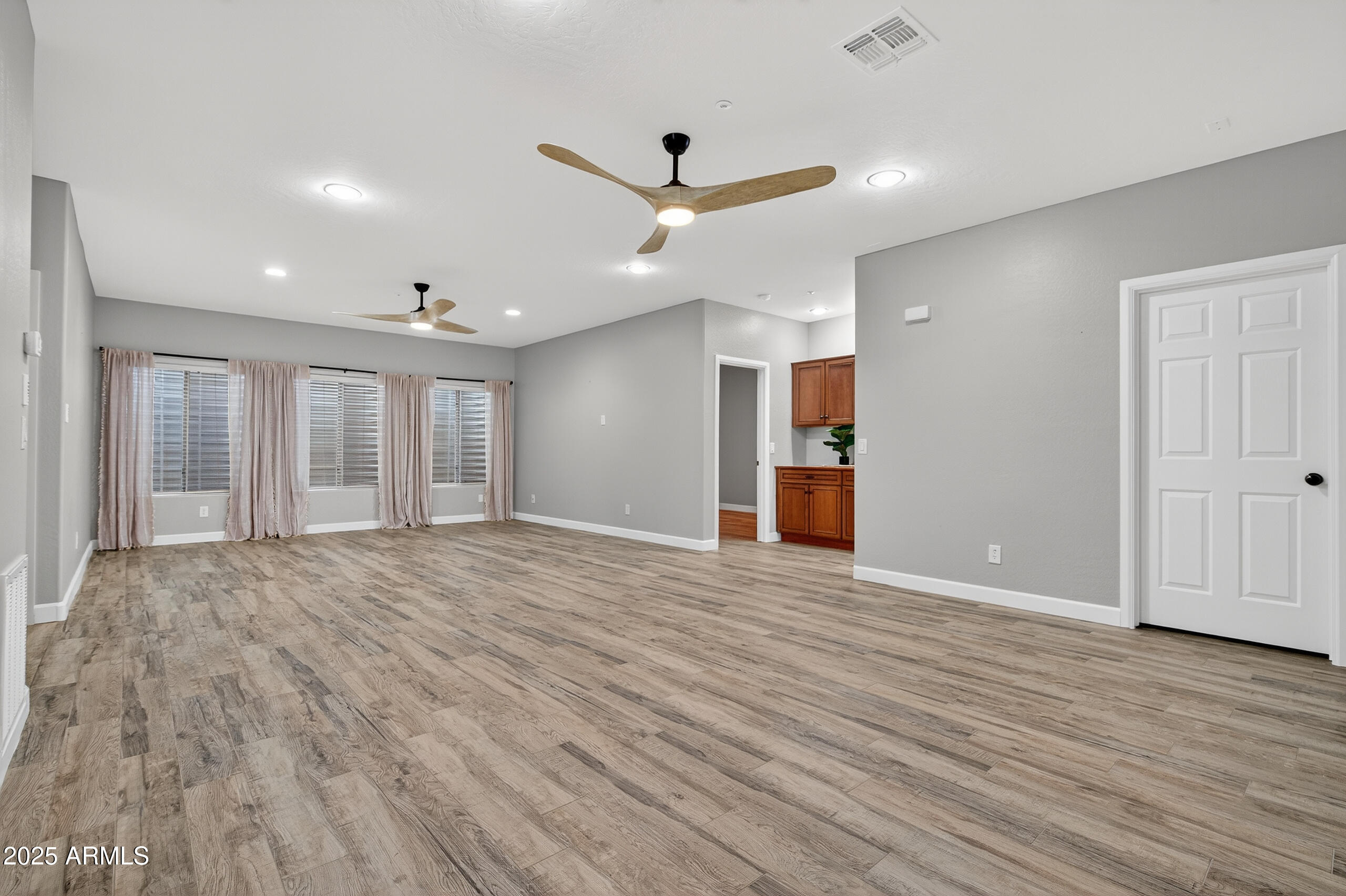 3021 East Agritopia Loop North Gilbert, AZ 85296 - Photo 30 of 68 a view of an empty room with wooden floor and a window