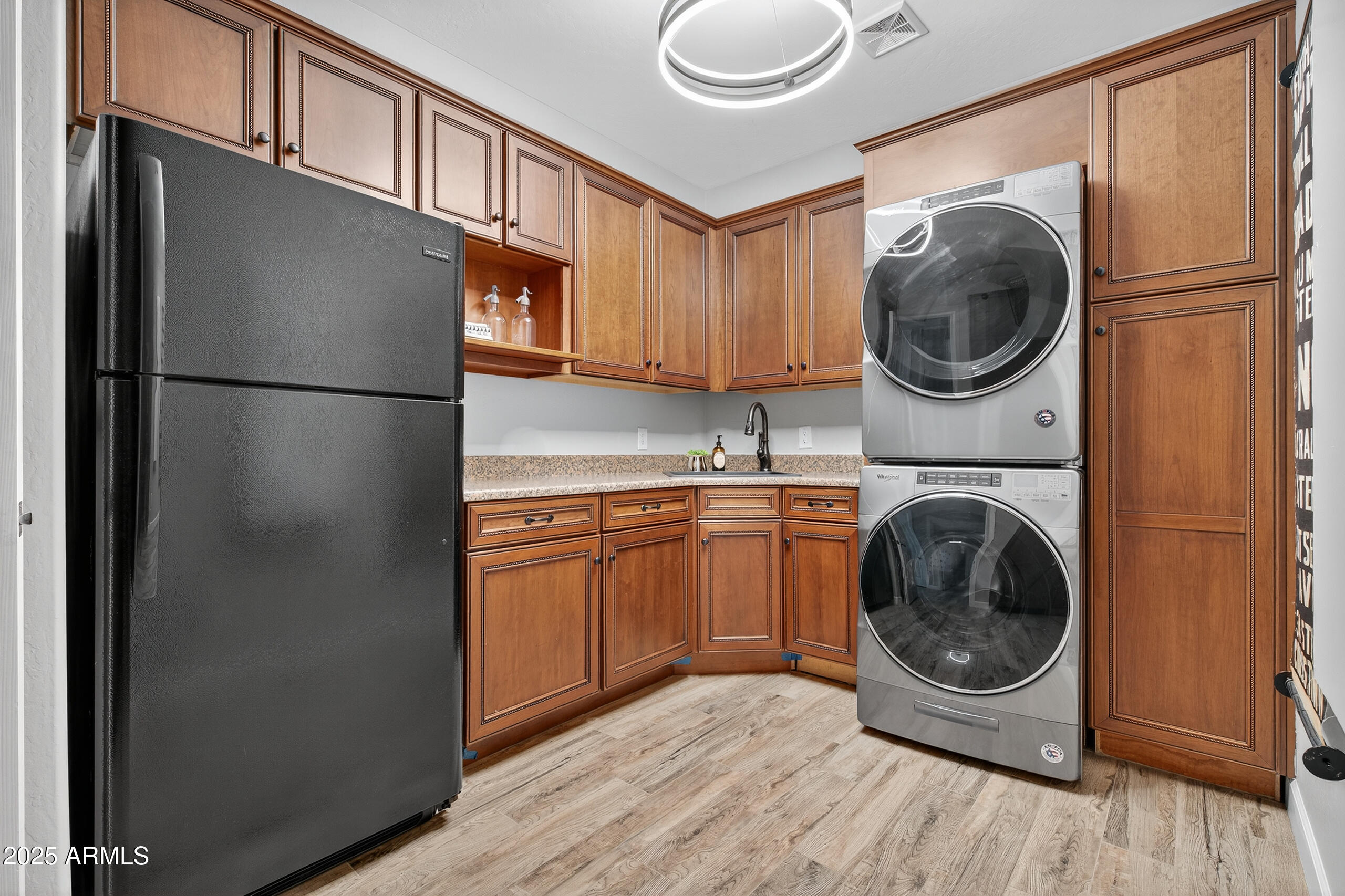 3021 East Agritopia Loop North Gilbert, AZ 85296 - Photo 38 of 68 a kitchen with a refrigerator and a washer dryer