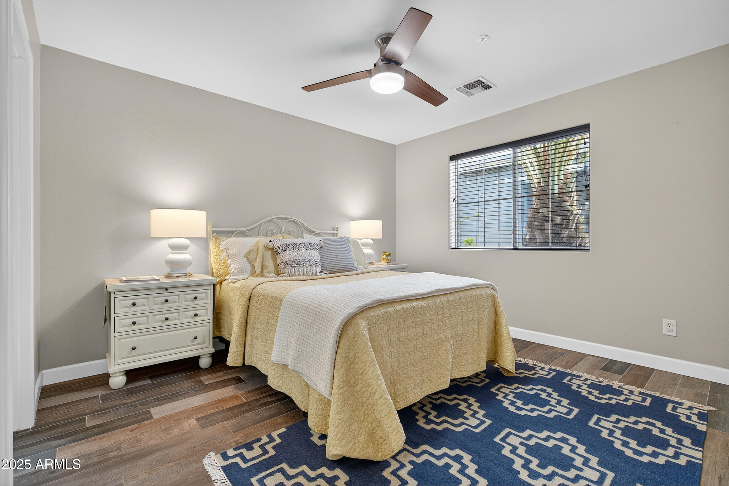 3021 East Agritopia Loop North Gilbert, AZ 85296 - Photo 46 of 68 a bedroom with a bed and a lamp on a dresser