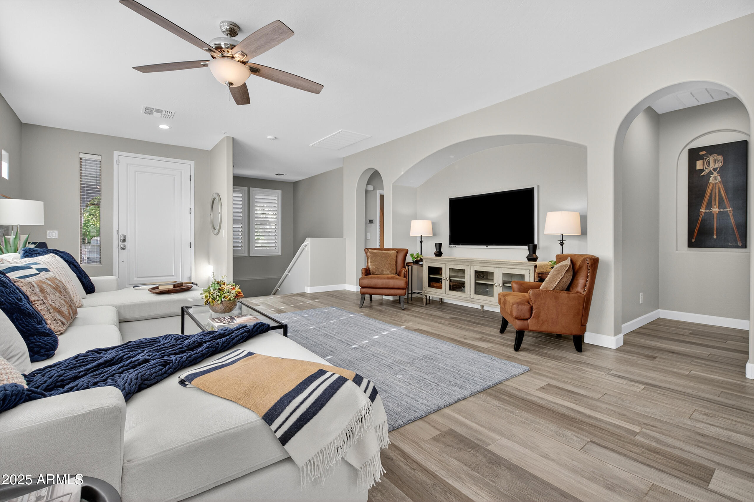 3021 East Agritopia Loop North Gilbert, AZ 85296 - Photo 5 of 68 a living room with furniture and a flat screen tv
