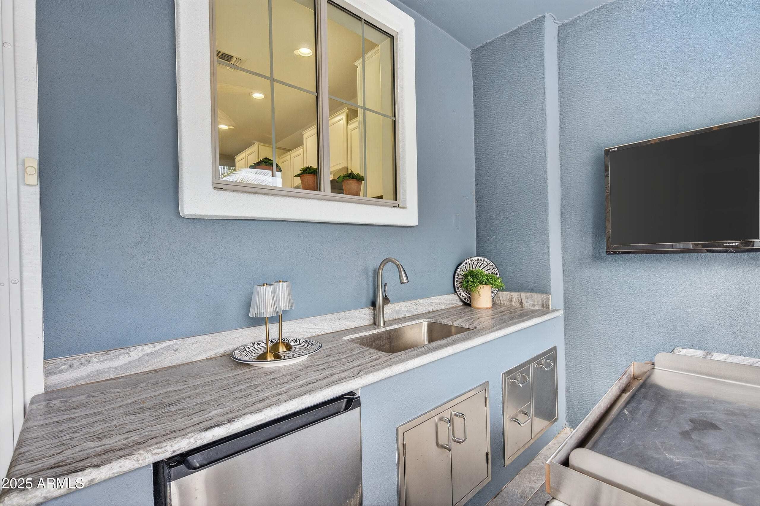 3021 East Agritopia Loop North Gilbert, AZ 85296 - Photo 52 of 68 a bathroom with a granite countertop sink a mirror and vanity