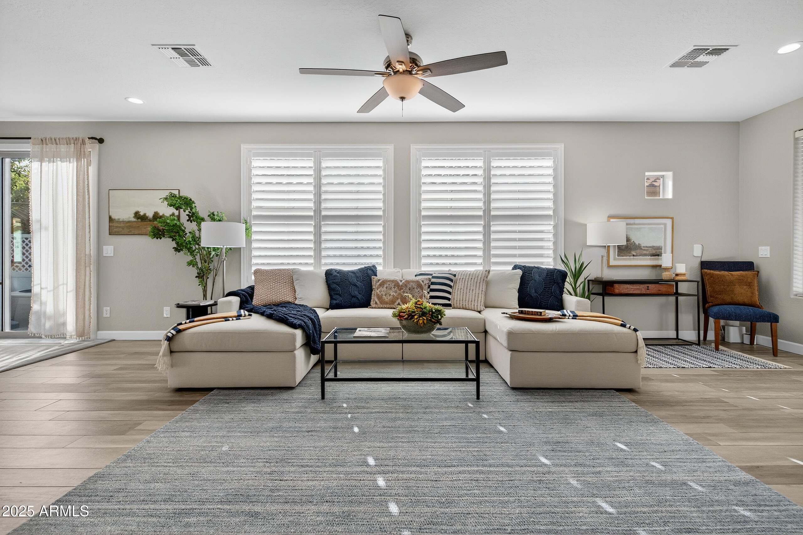 3021 East Agritopia Loop North Gilbert, AZ 85296 - Photo 6 of 68 a living room with furniture and a large window