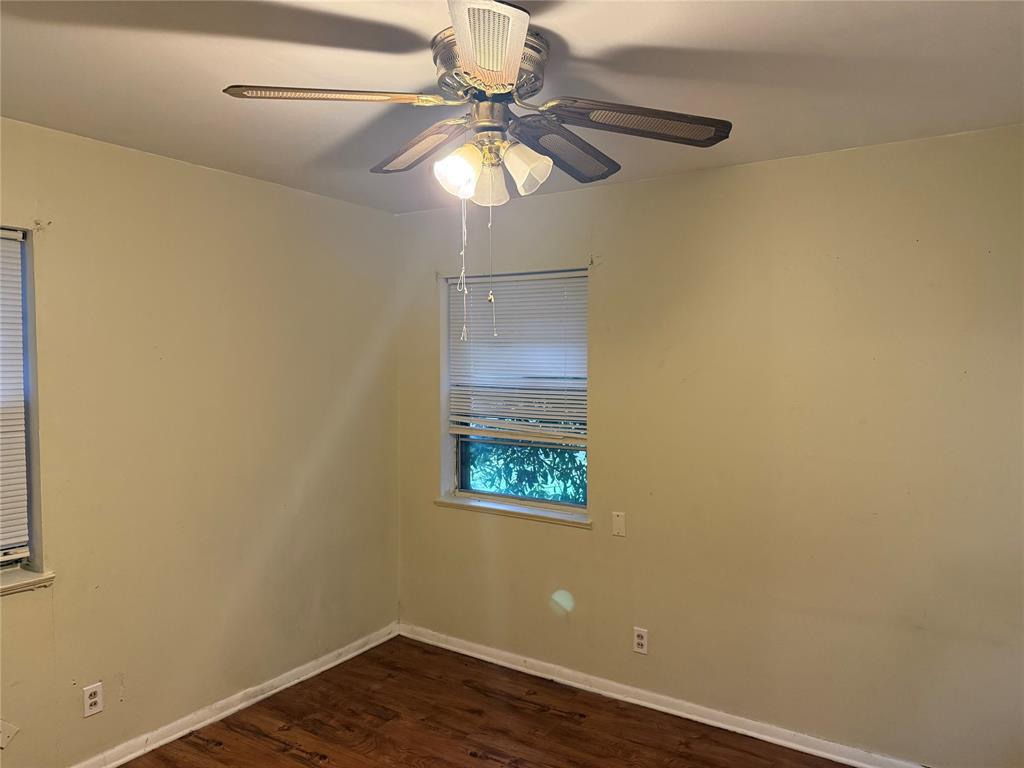 1007 Westway Street Denton, TX 76201 - Photo 6 of 15 an empty room with wooden floor and fan