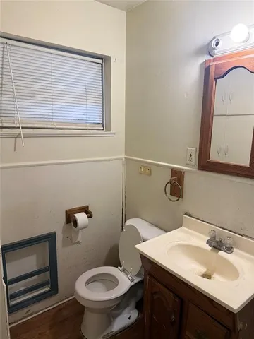 a bathroom with a sink a toilet and a mirror