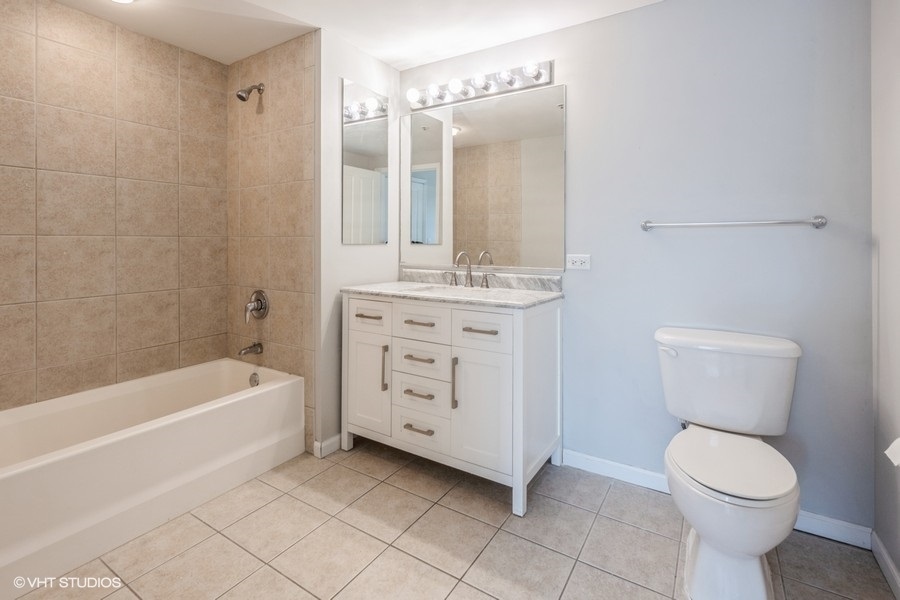 4848 North Sheridan Road, Unit 208 Chicago, IL 60640 - Photo 13 of 15 a bathroom with a sink a toilet and shower