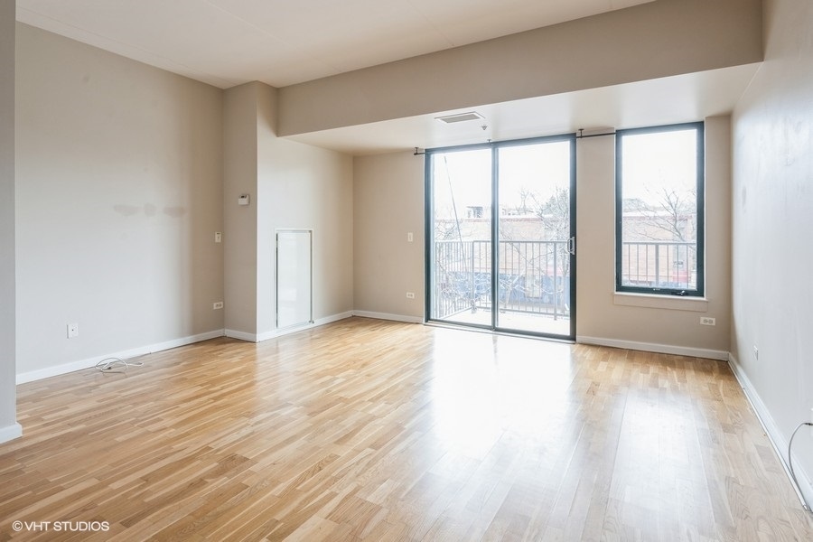 4848 North Sheridan Road, Unit 208 Chicago, IL 60640 - Photo 5 of 15 wooden floor in an empty room with a window