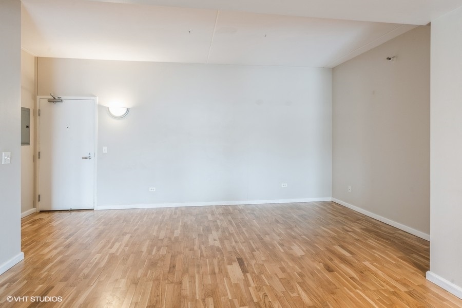 4848 North Sheridan Road, Unit 208 Chicago, IL 60640 - Photo 8 of 15 a view of an empty room with wooden floor