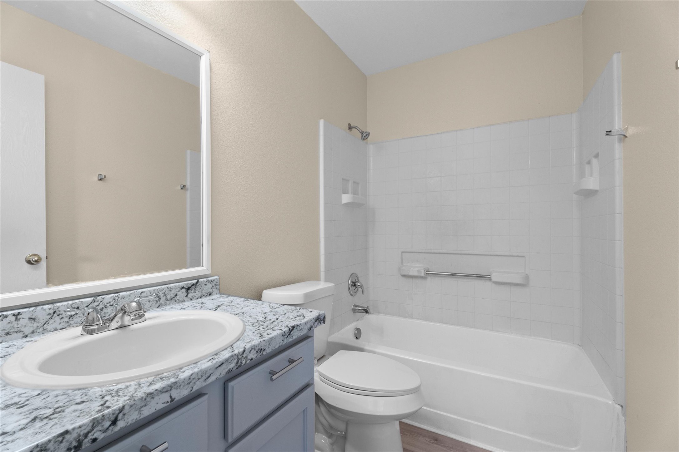 172 Discovery Kyle, TX 78640 - Photo 14 of 21 Clean bathroom with updated vanity, bright lighting, and a tub and shower combo.