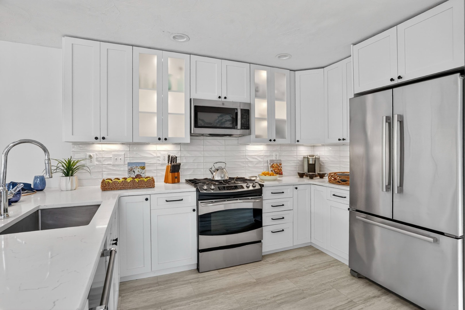 9 Thaxter Lane Edgartown, MA 02539 - Photo 17 of 53 a kitchen with white cabinets and stainless steel appliances