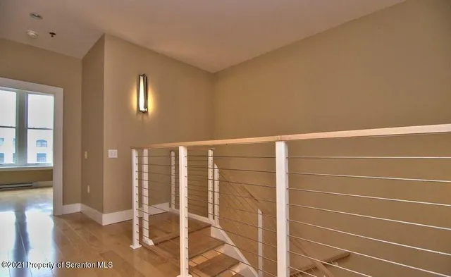 a view of a room with wooden floor and windows