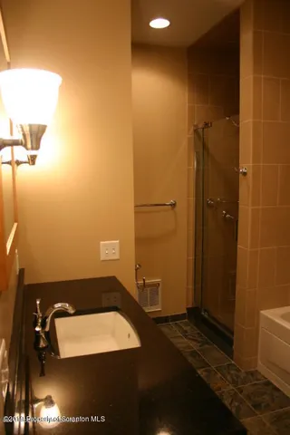 a bathroom with a sink and a shower