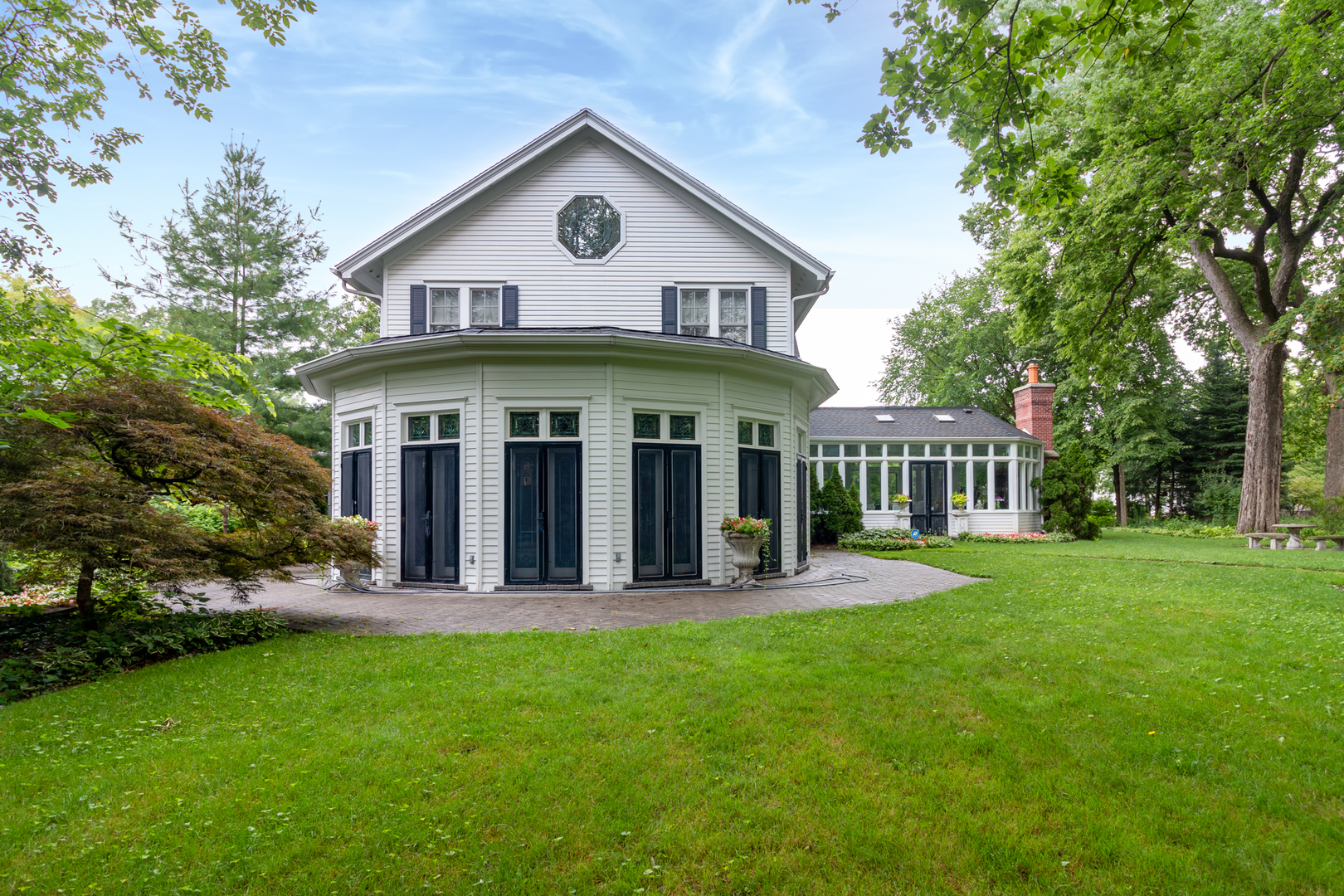 201 Scottswood Road Riverside, IL 60546 - Photo 4 of 75 a front view of a house with a yard porch and outdoor seating