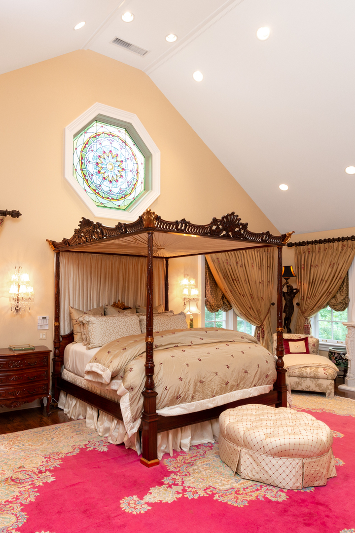 201 Scottswood Road Riverside, IL 60546 - Photo 39 of 75 a bedroom with a bed and a chandelier