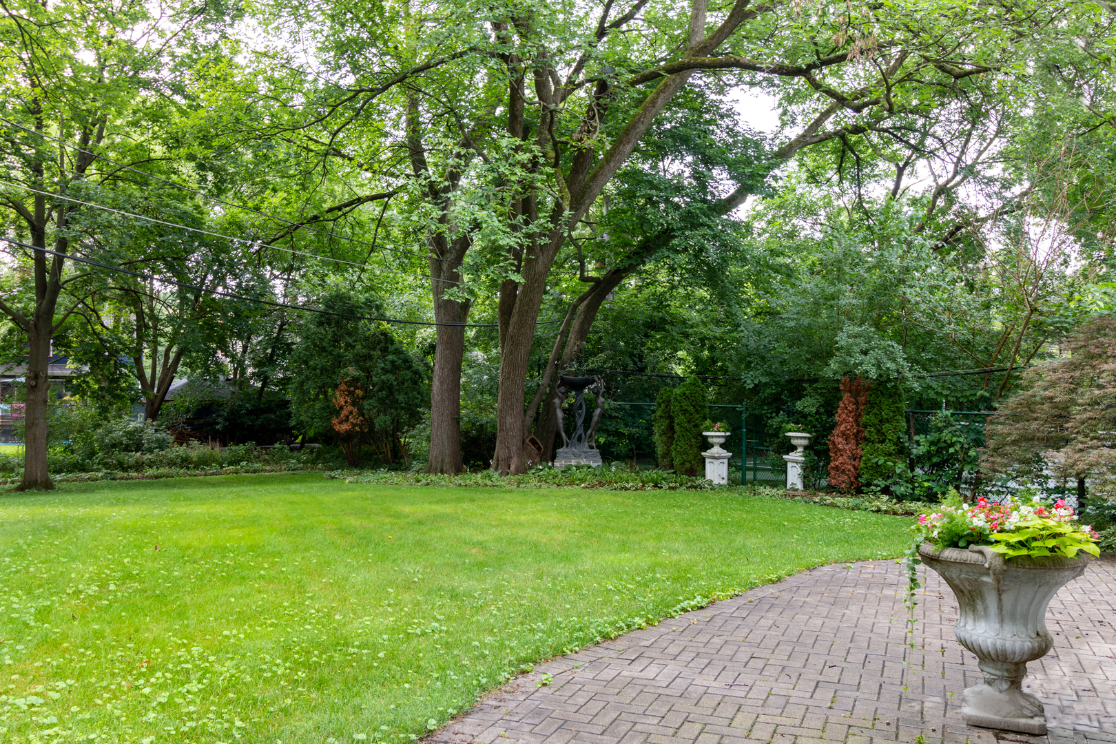201 Scottswood Road Riverside, IL 60546 - Photo 7 of 75 a view of a garden with a fountain