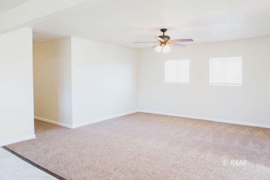 148 South Sunset Street Ridgecrest, CA 93555 - Photo 11 of 25 an empty room with windows and fan